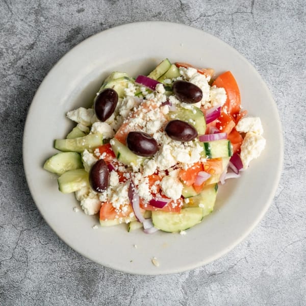 Opa Grille's Greek salad with cucumbers, tomatoes, red onions, feta cheese, and Kalamata olives.