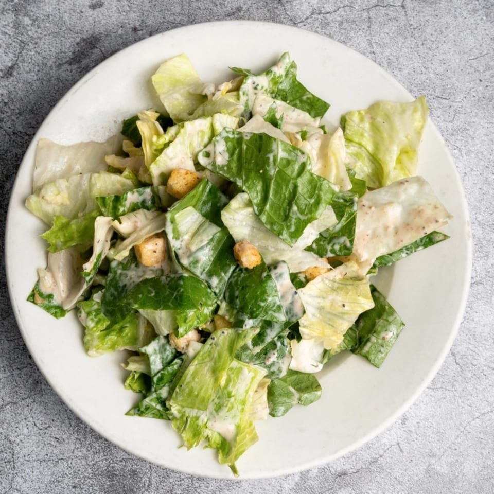 Opa Grille's Caesar salad, featuring crisp romaine lettuce, creamy dressing, and crunchy croutons.